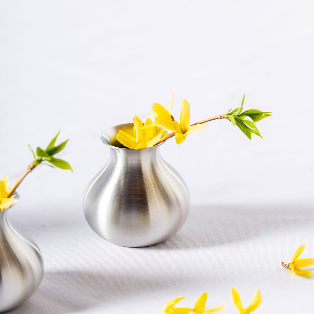 Small pewter vase with yellow flowers