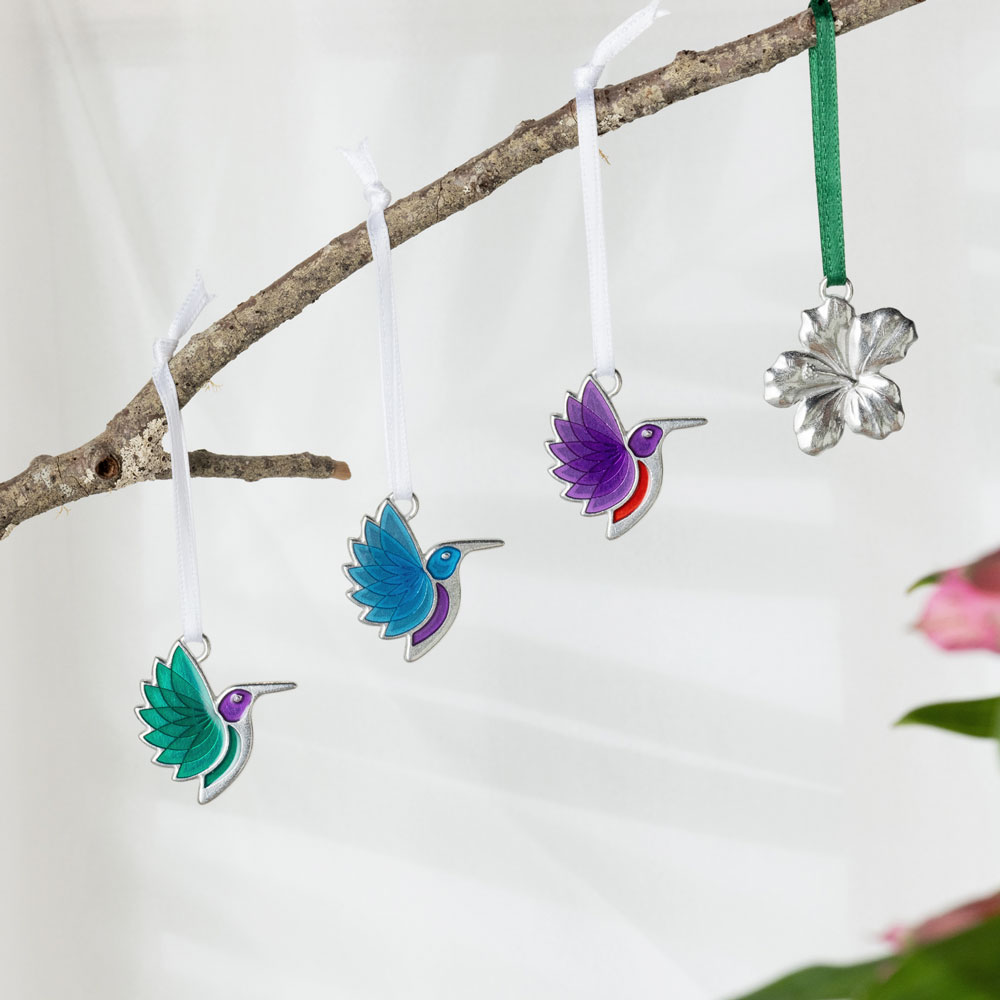 3 Brightly colored small hummingbird ornaments and one hibiscus ornament