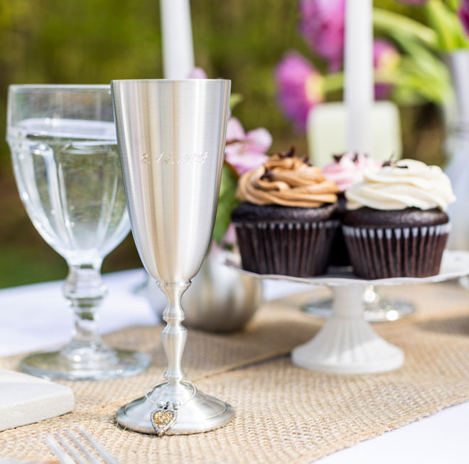 Pewter champagne flute with a date engraved on it