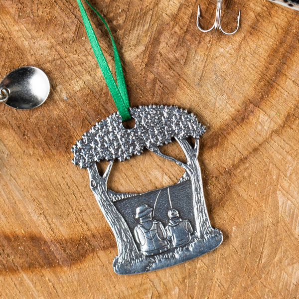 Pewter ornament showing adult and child fishing together