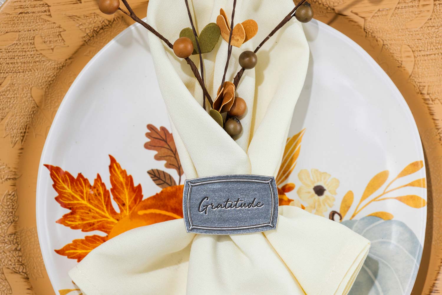 Gratitude napkin ring on a napkn on a plate